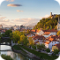 Aerial view of Zagreb city center featuring the Zagreb Cathedral with twin spires and surrounding historic buildings under a partly cloudy sky.