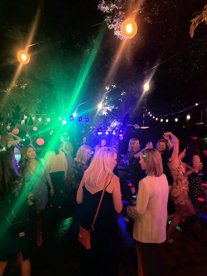 Guests dancing in a Perth garden at night under festoon lights