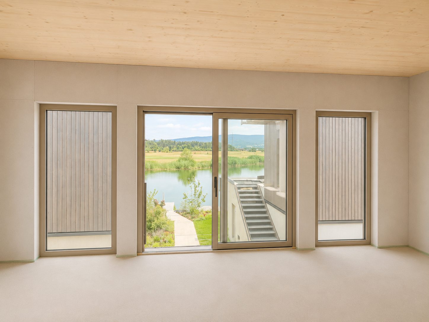 Wohnbereich mit großer Glasfront und Seeblick