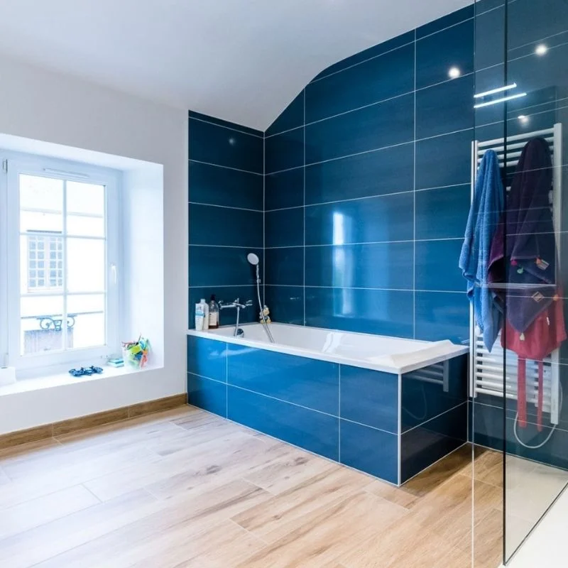 Salle de bain moderne bleue avec douche italienne après rénovation, réalisation So!cozi
