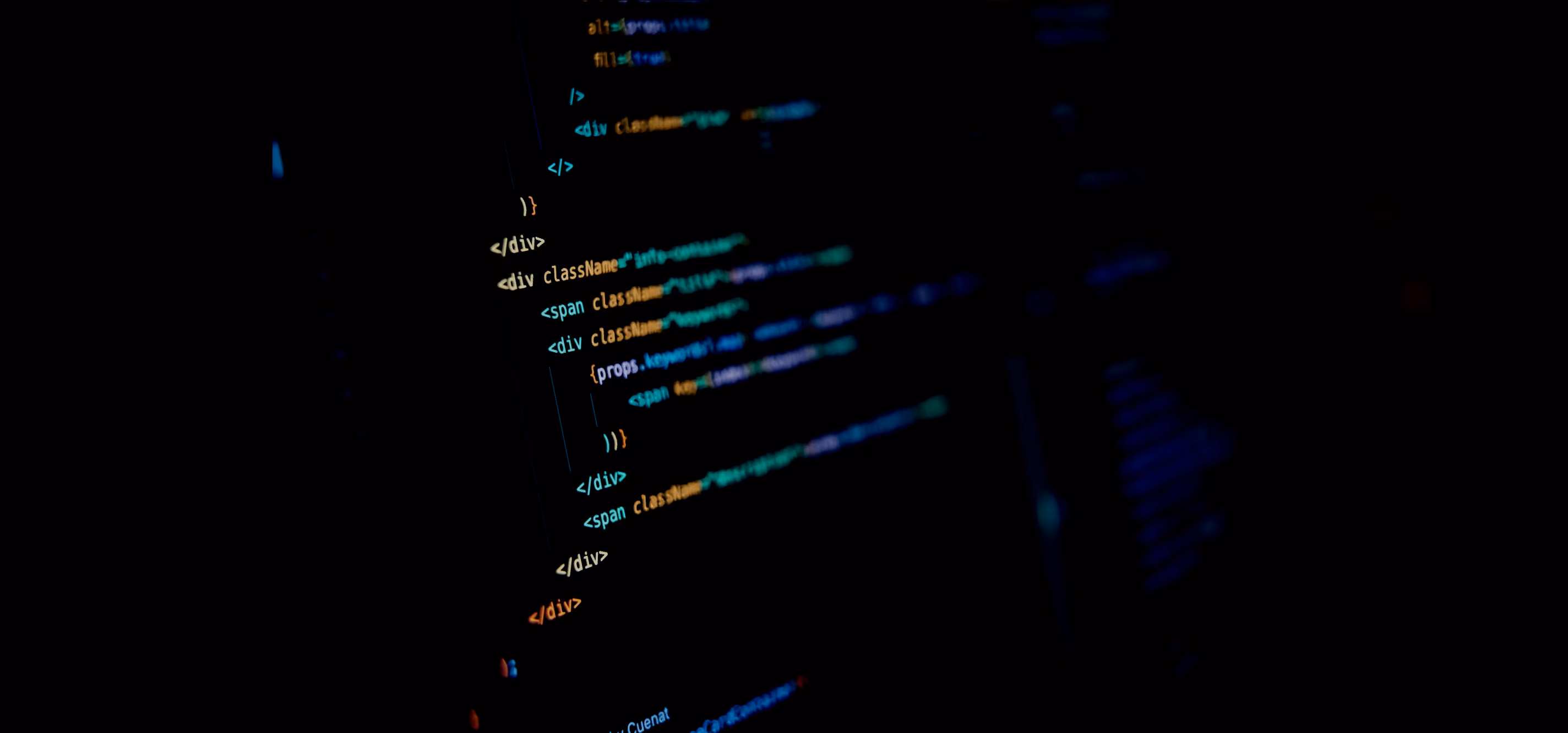 Blurred dark screen showing color-coded HTML and JavaScript code lines for a website layout.