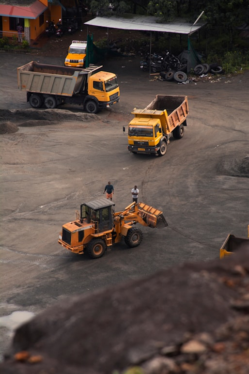Wheel loader and dump trucks working an earthworks site