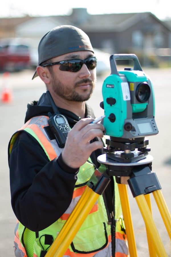 man in black jacket holding blue and black camera