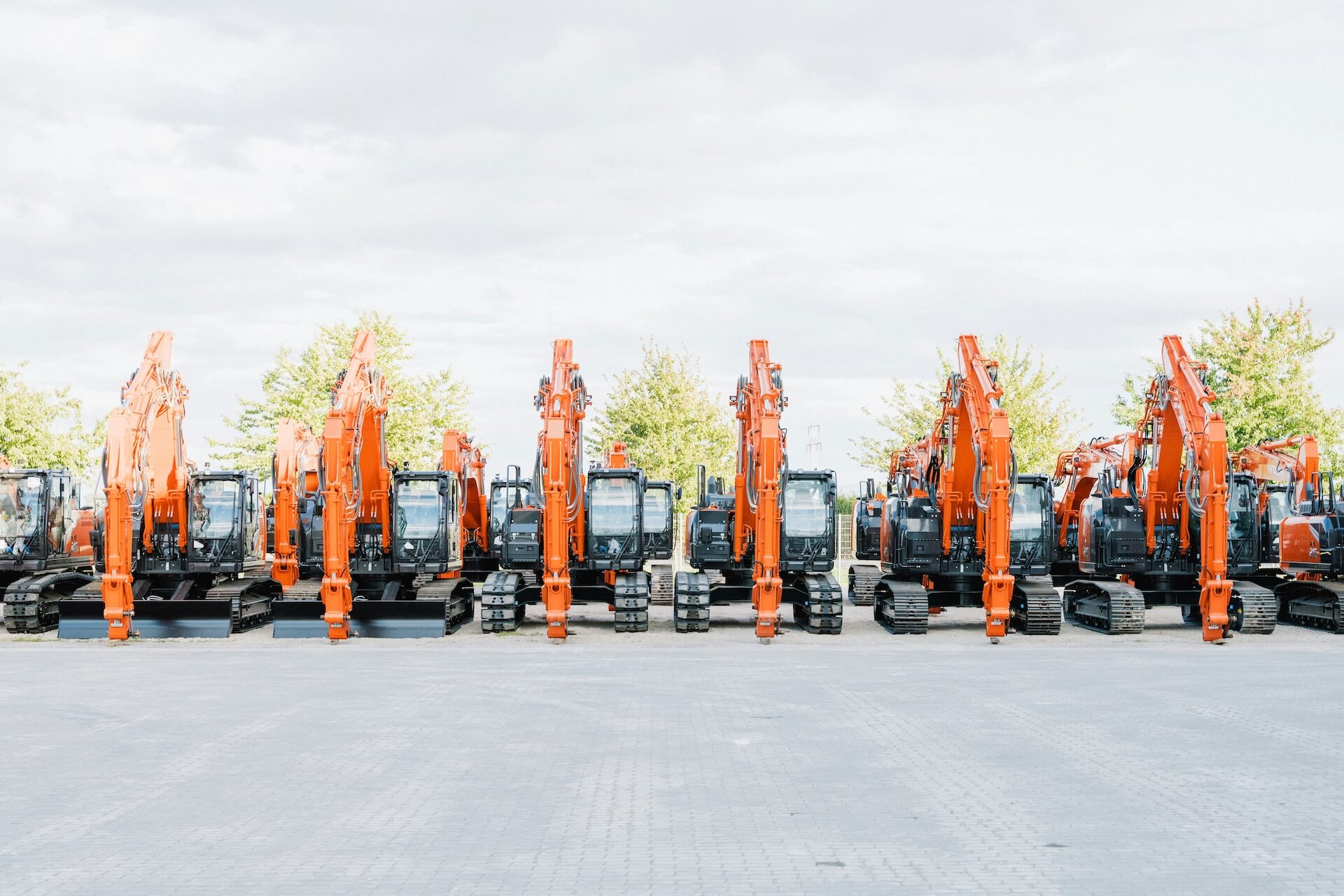 Row of Hitachi excavators lined up ready for delivery