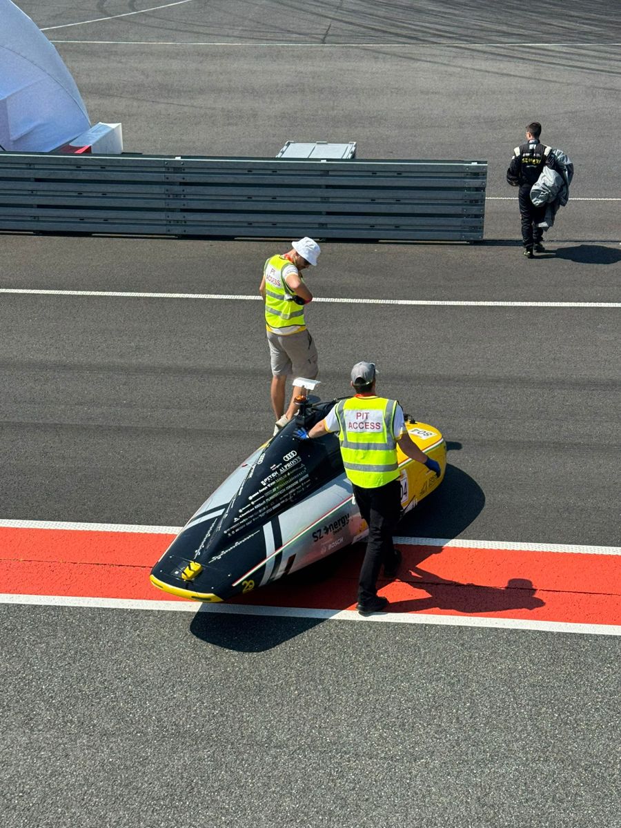 Prototype vehicle being moved along a race track pit lane