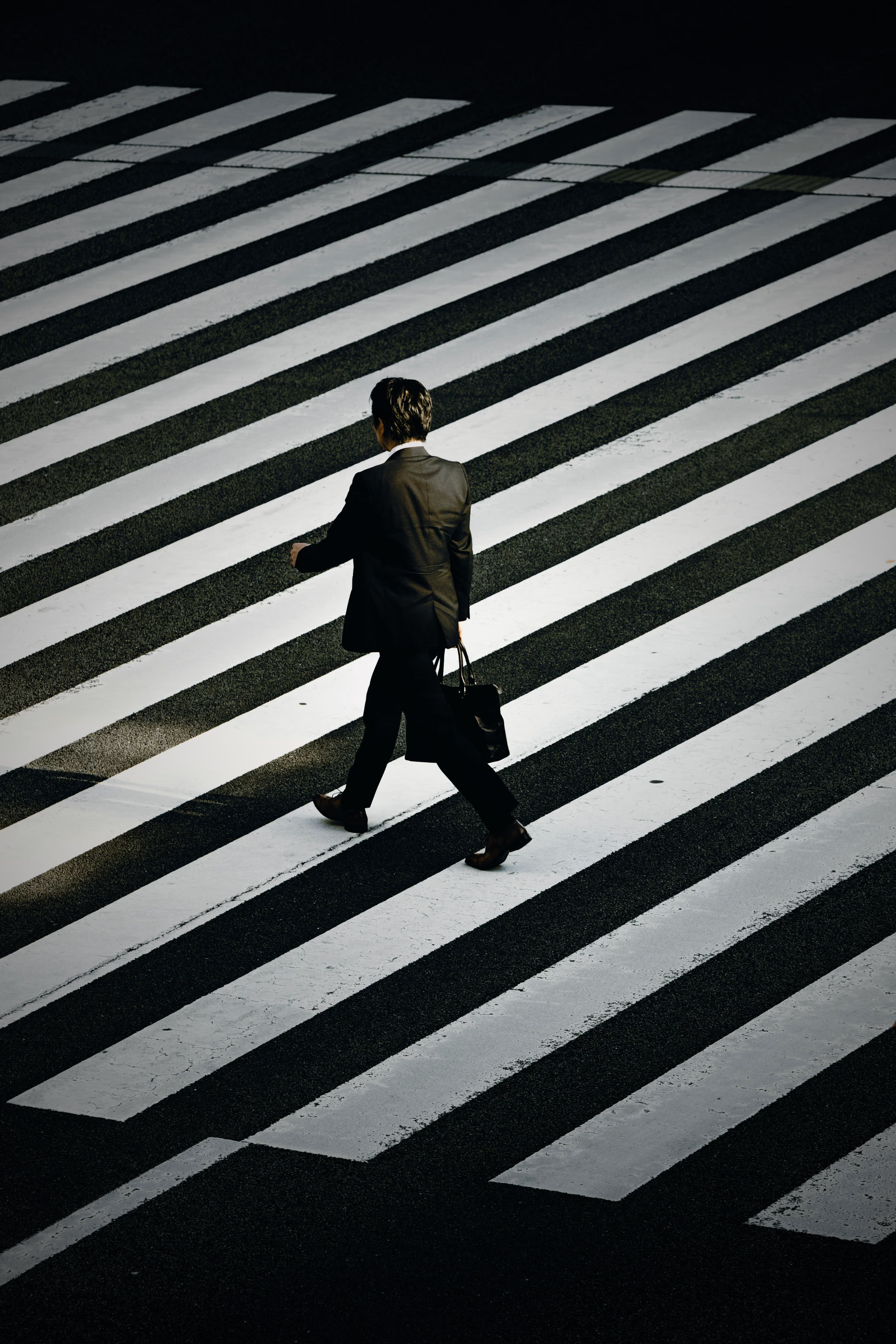 Commuters crossing a busy city street