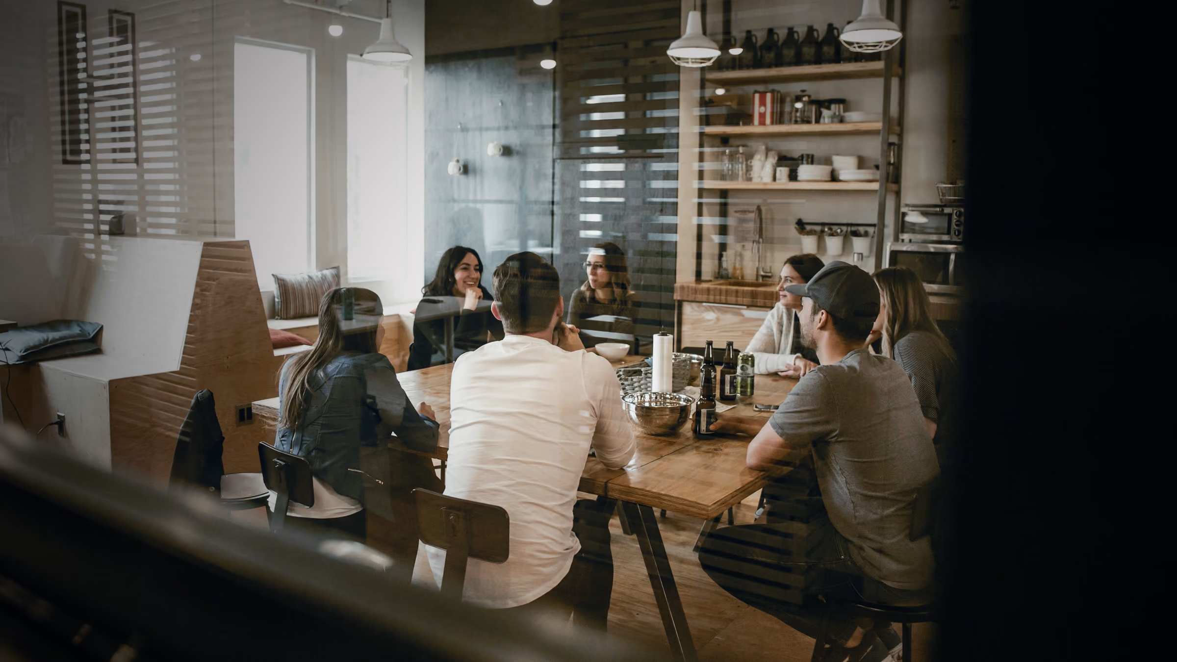 Colleagues meeting in a glass-walled meeting room