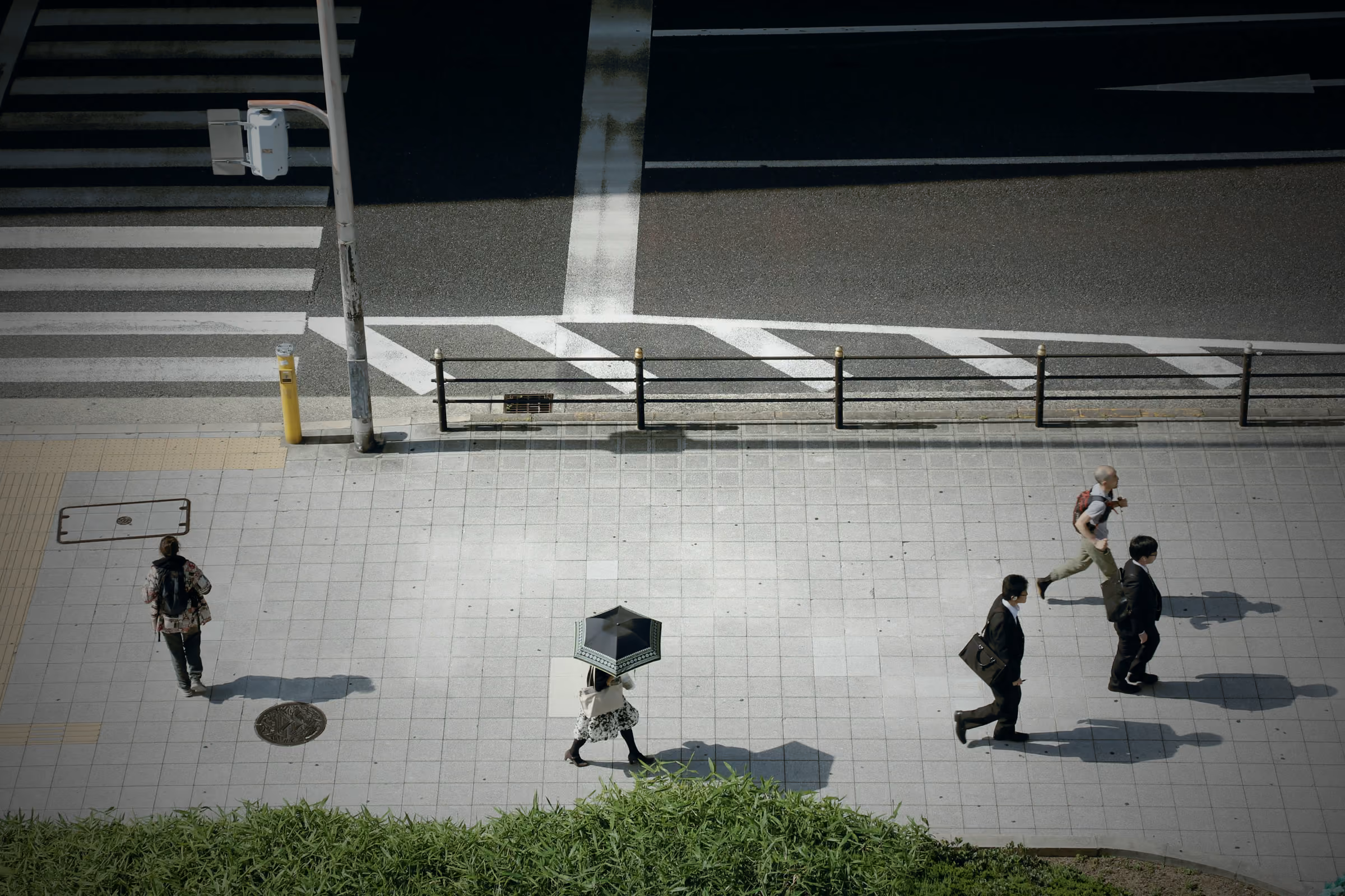 Overhead view of people crossing a city street