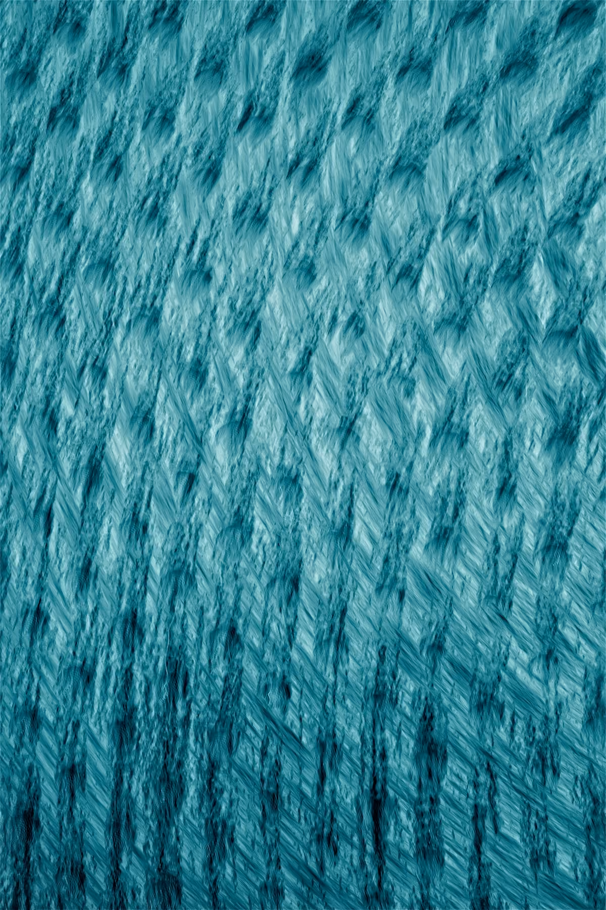 Close-up of a textured surface with blue-green brushed streaks creating a rough, fibrous pattern across the image.