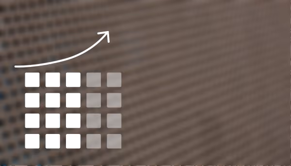 Grid of white and gray squares with an upward curved arrow above, symbolizing growth or progress on a blurred building background.