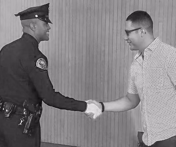 Police officer shaking hands with a community member