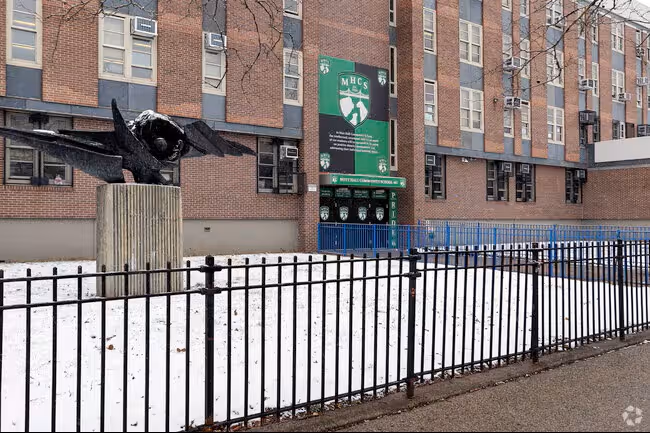 MHCS school building exterior with eagle sculpture and green banner in winter