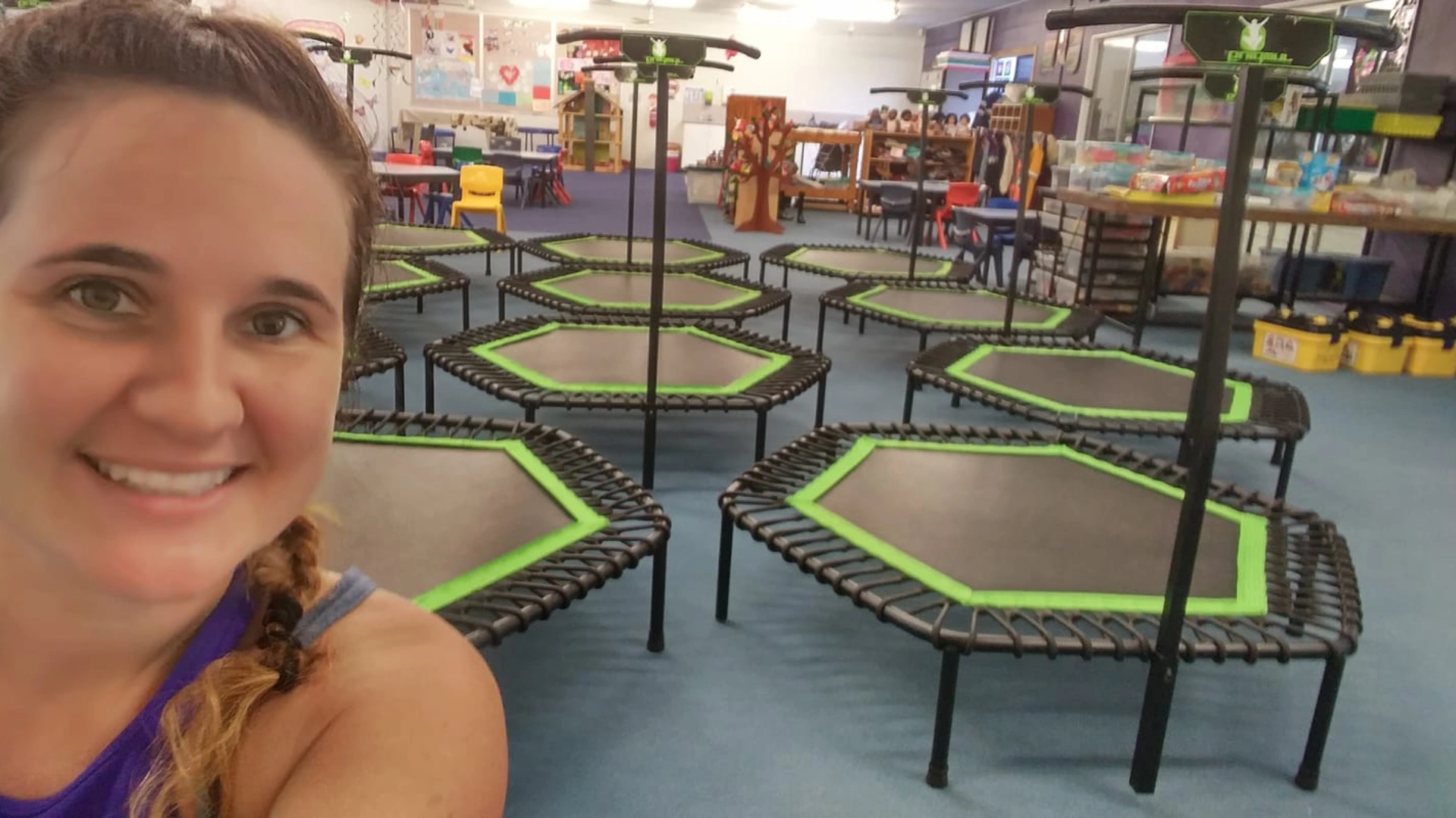 Instructor taking a selfie inside Bounc'd NQ in Earlville, QLD, with rebounder trampolines set up for a group fitness class.