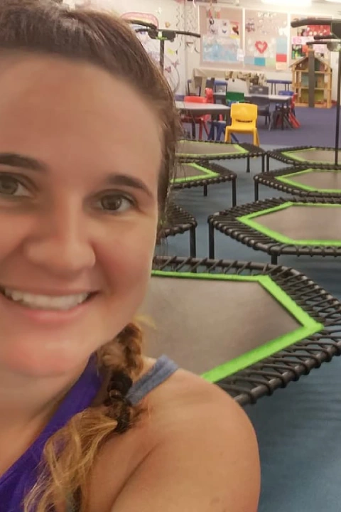 Instructor taking a selfie inside Bounc'd NQ in Earlville, QLD, with rebounder trampolines set up for a group fitness class.