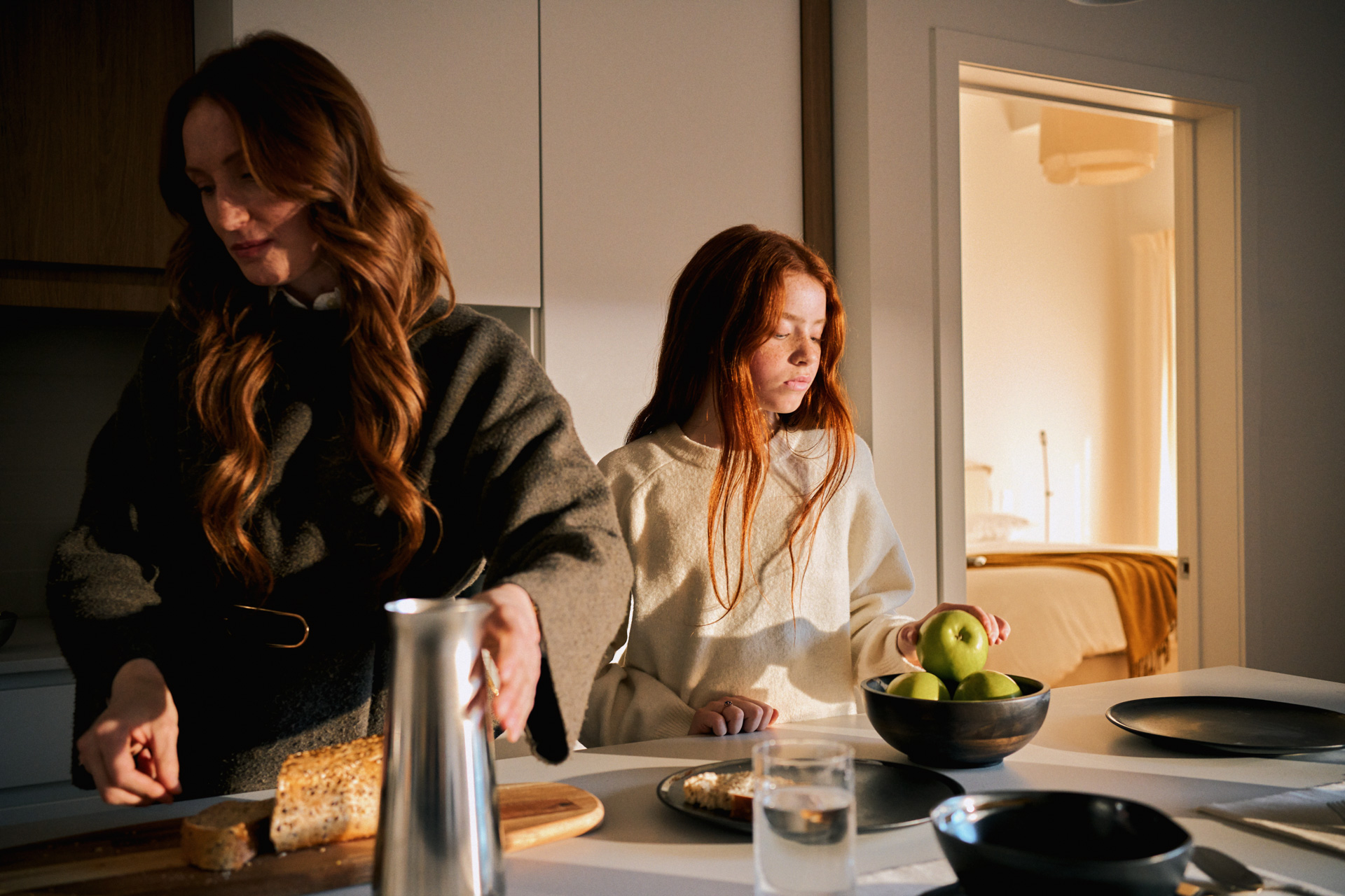 Mother and daughter preparing breakfast in the bright open kitchen of a Rive Lac Tremblant condo