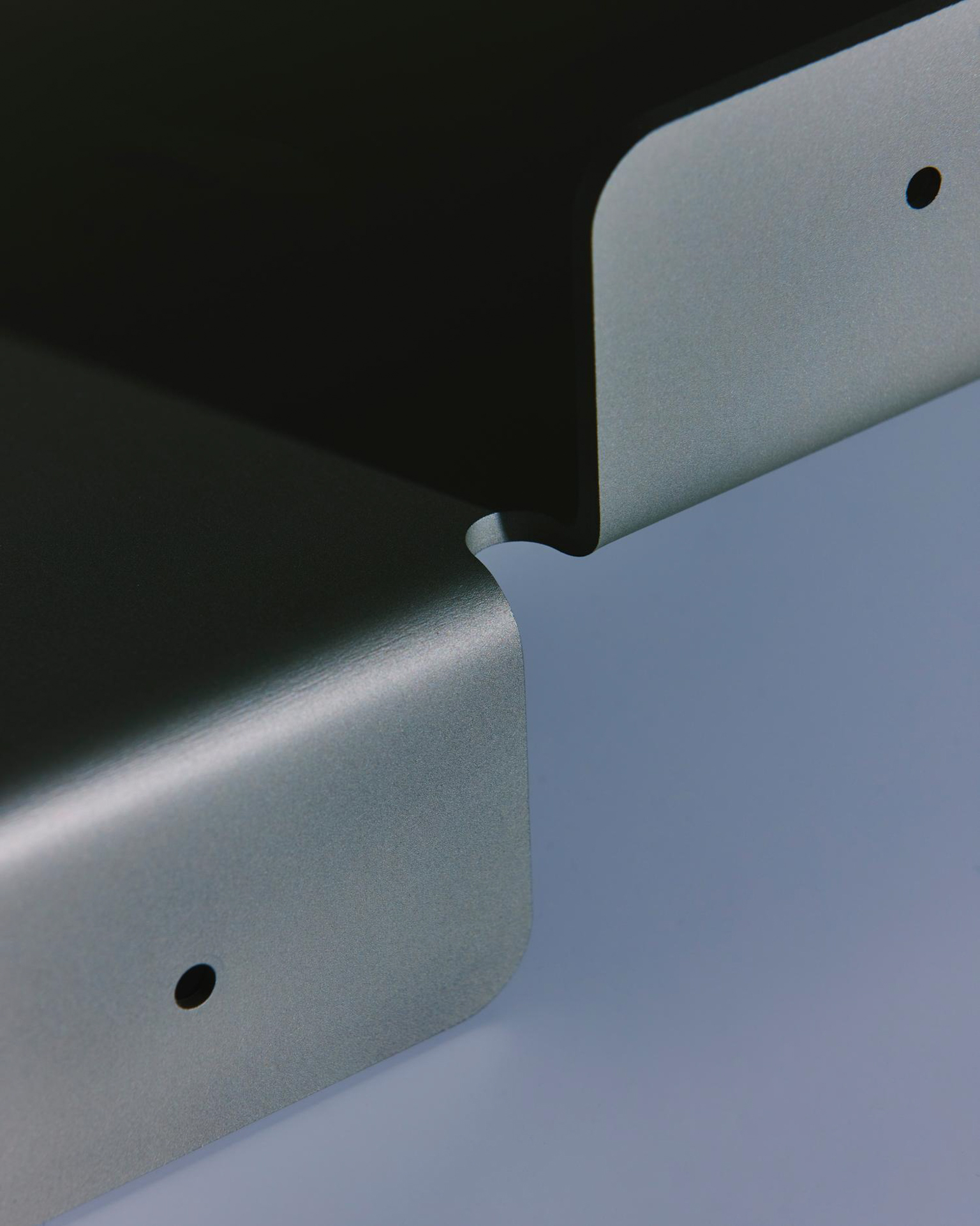 Close-up of the rounded corners of a metal shelf by LESORR