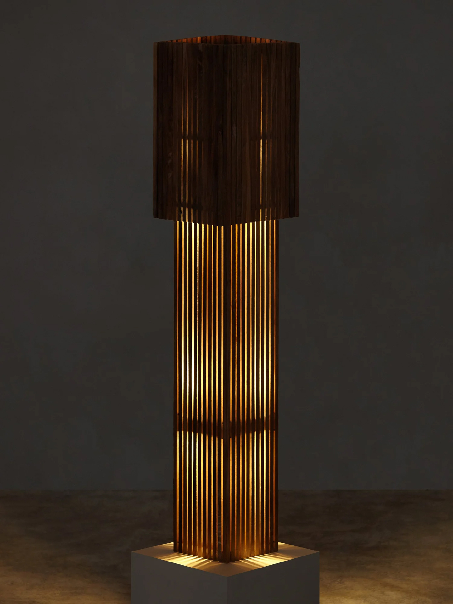 Slatted walnut floor lamp by Stamatios glowing warmly in a dark room