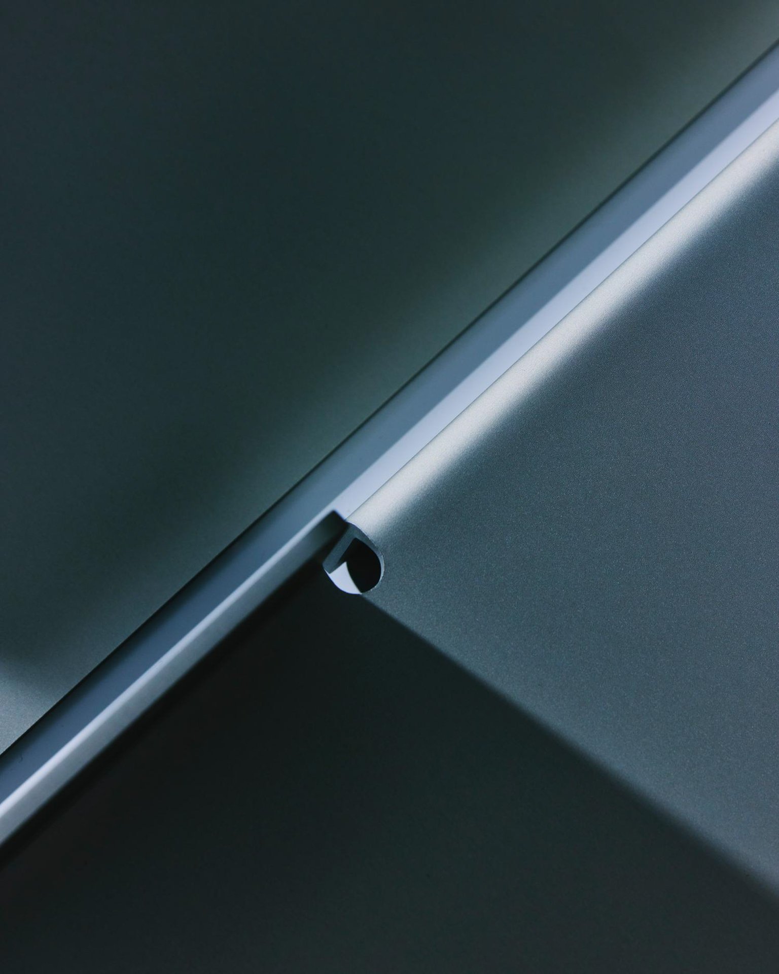 Close-up of the folded edge of a powder-coated metal shelf by LESORR