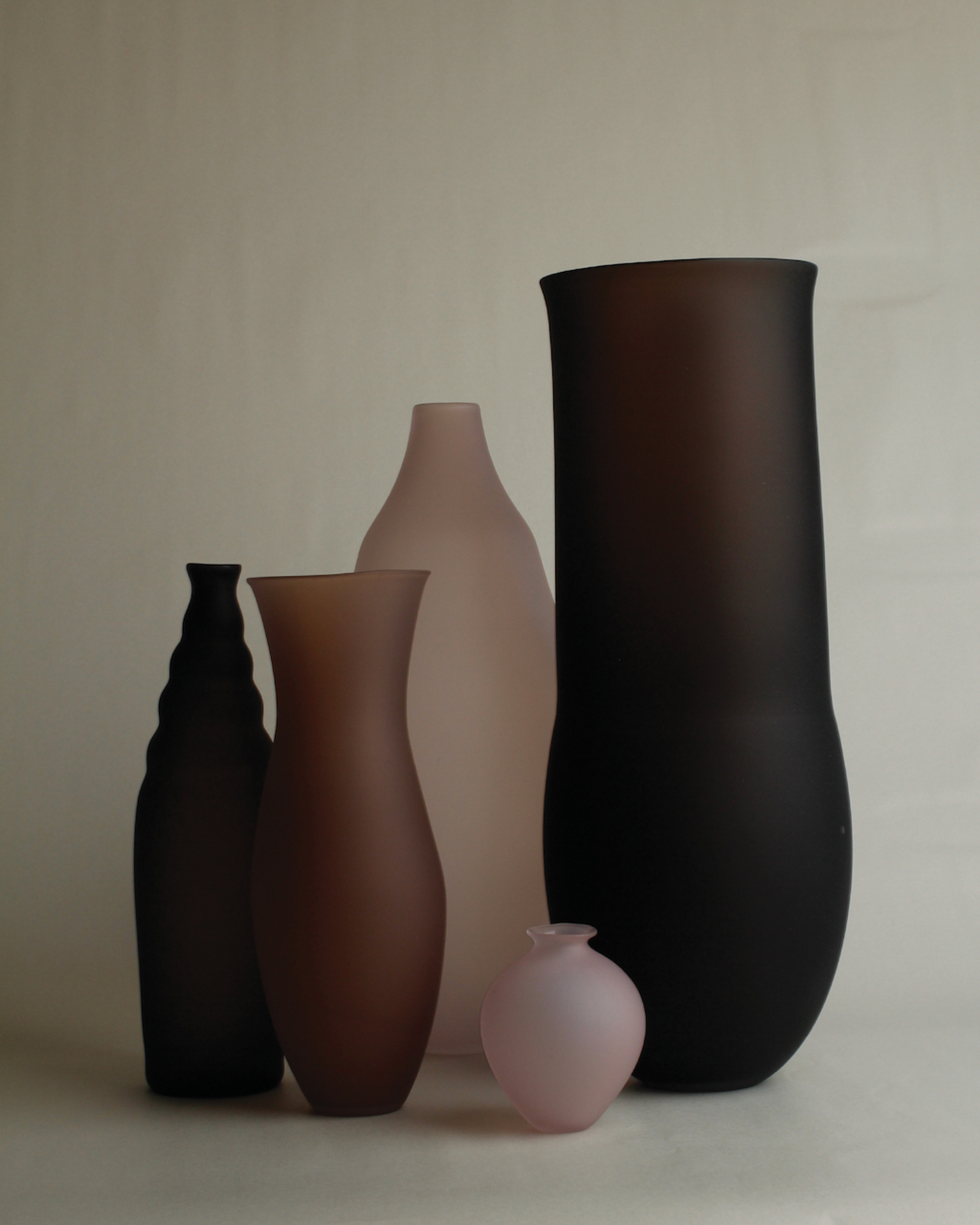 Collection of frosted glass vases in plum and blush tones by Verre d'Onge