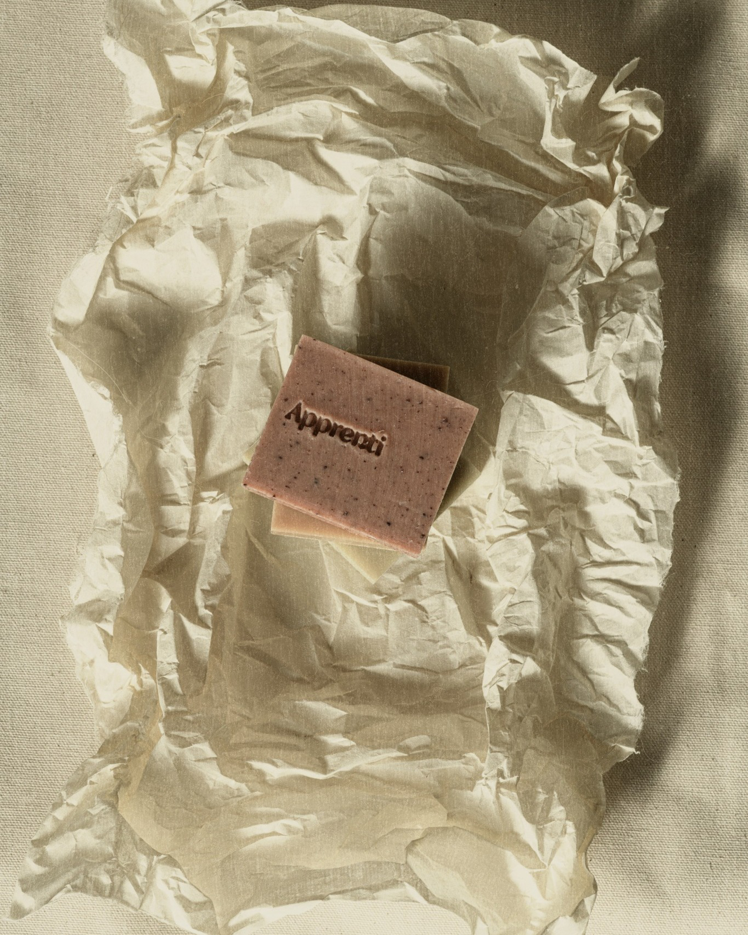 Handmade Apprenti soap bar on crinkled paper, a local brand featured in the Rive Lac Tremblant showroom