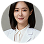 Smiling woman with dark hair wearing a white blouse in a circular frame.