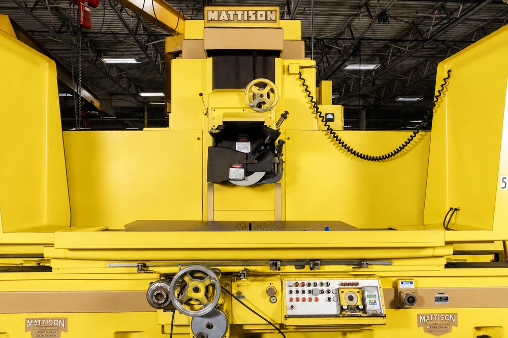 Mattison surface grinder with the wheel head above its long grinding table