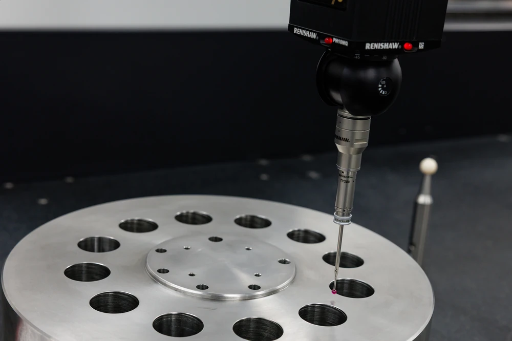 CMM probe with a ruby stylus measuring a bored hole in a machined flange