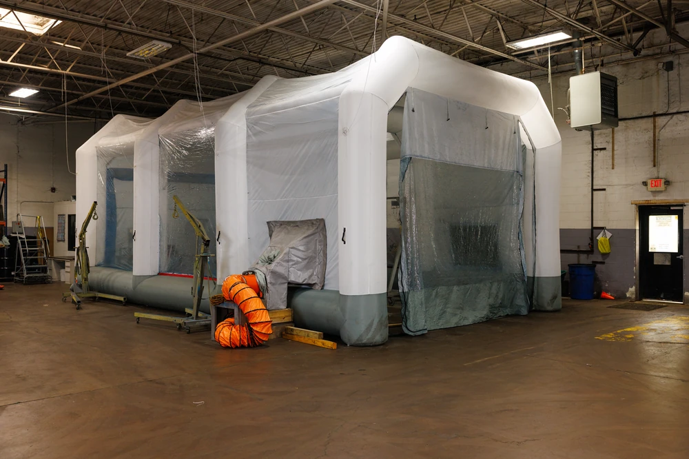Inflatable spray booth set up on the shop floor for painting