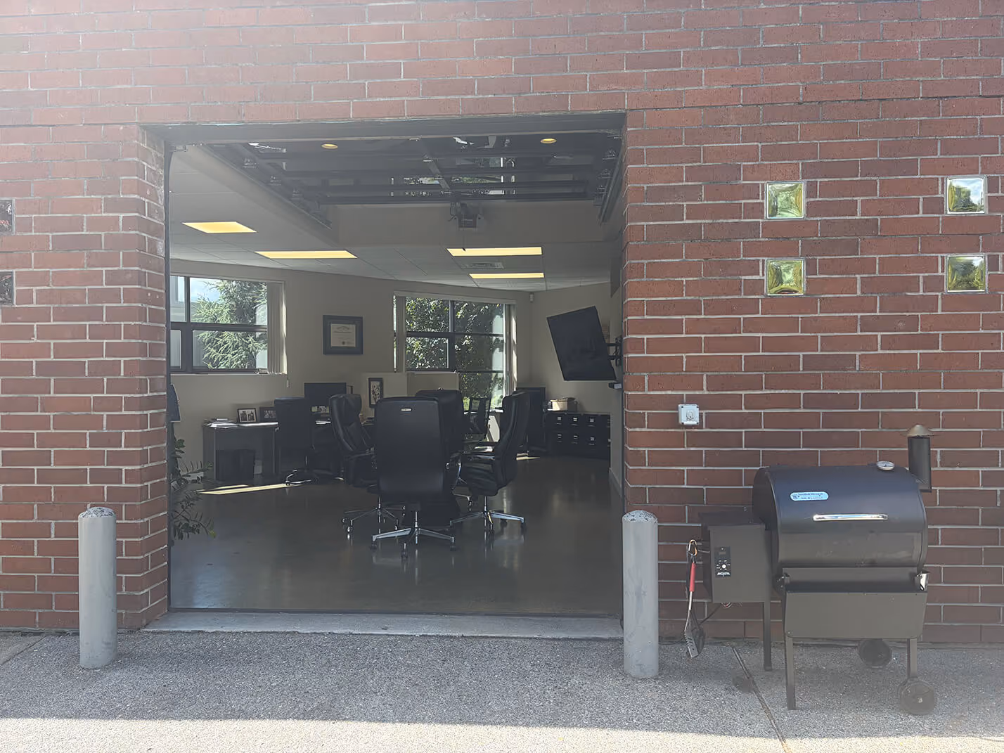 SMB's office with a garage door and Traeger grill outside