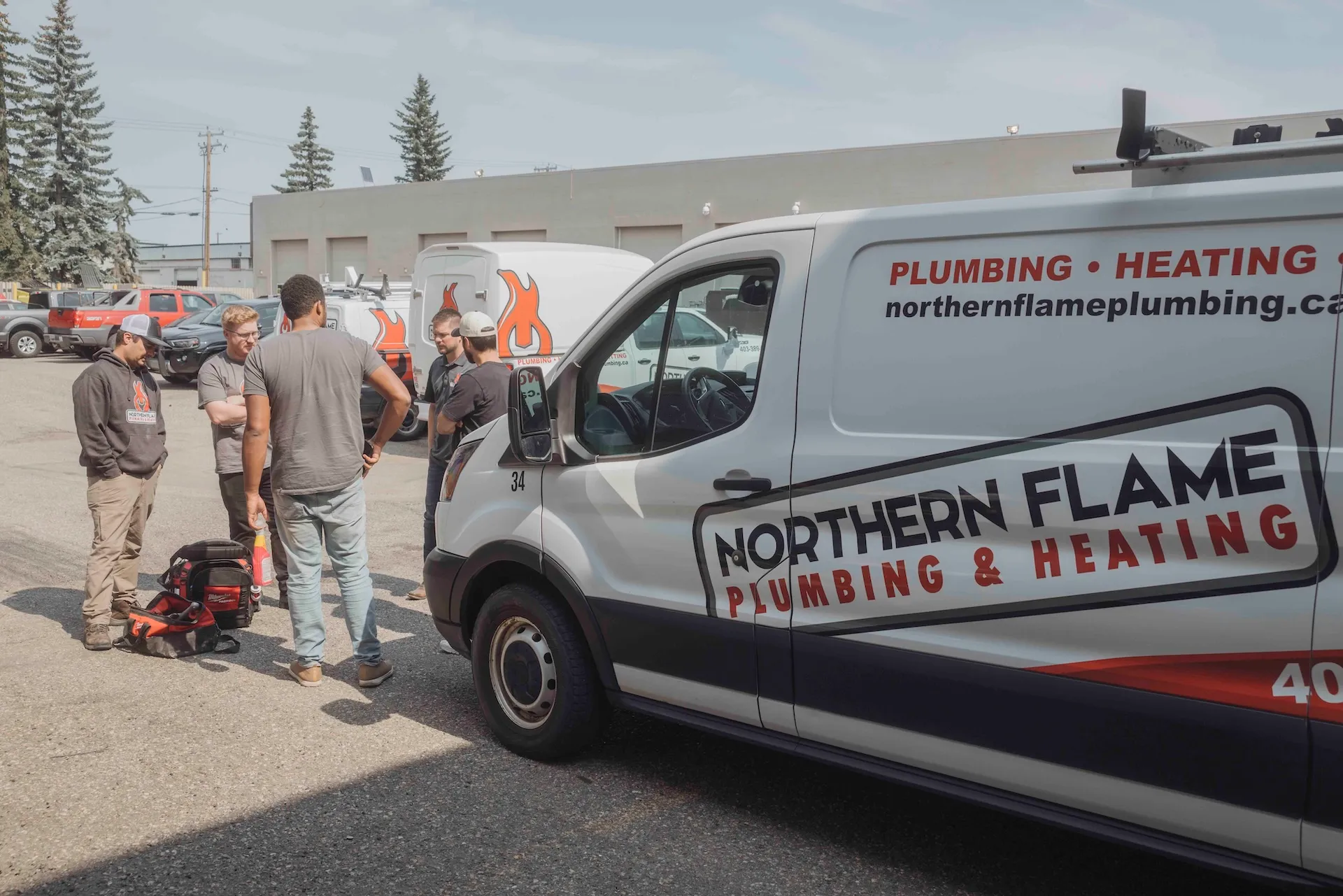 Northern Flame team gathered outside the shop beside a service van