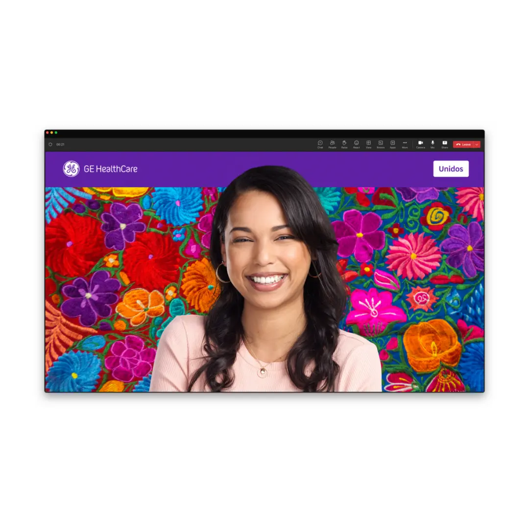 Presenter in front of a GE HealthCare branded virtual meeting backdrop