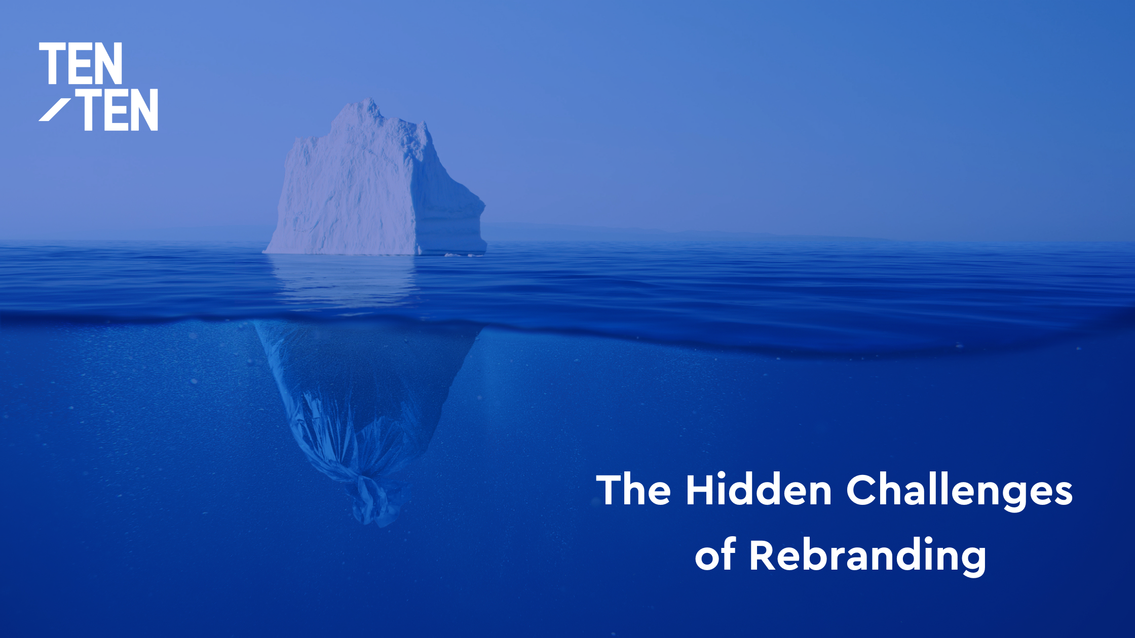 An iceberg in blue water, with most of its mass hidden below the surface.