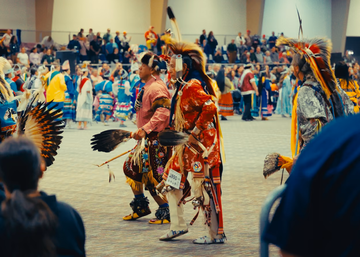 Native Americans dancing at PowWow. Indigenous informed mental health care.