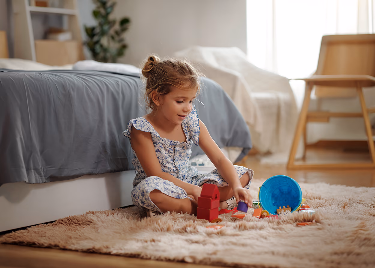 Child playing with toys during a play therapy session in a warm, welcoming therapy office