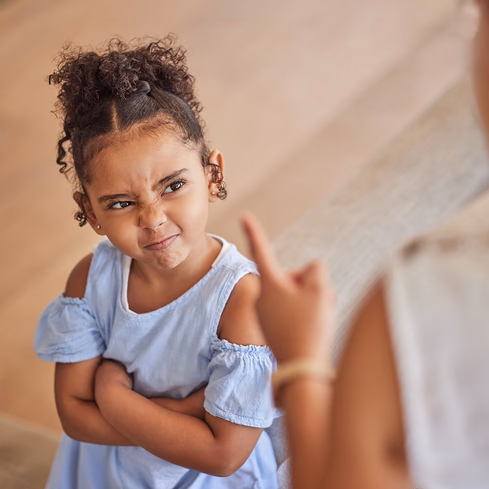 Young child working through emotions with toys during a behavioral play therapy session