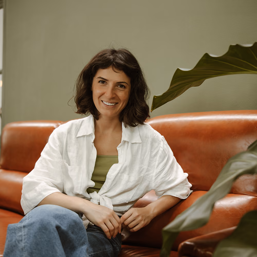 Woman in an open, comfortable conversation with her therapist in a warm office
