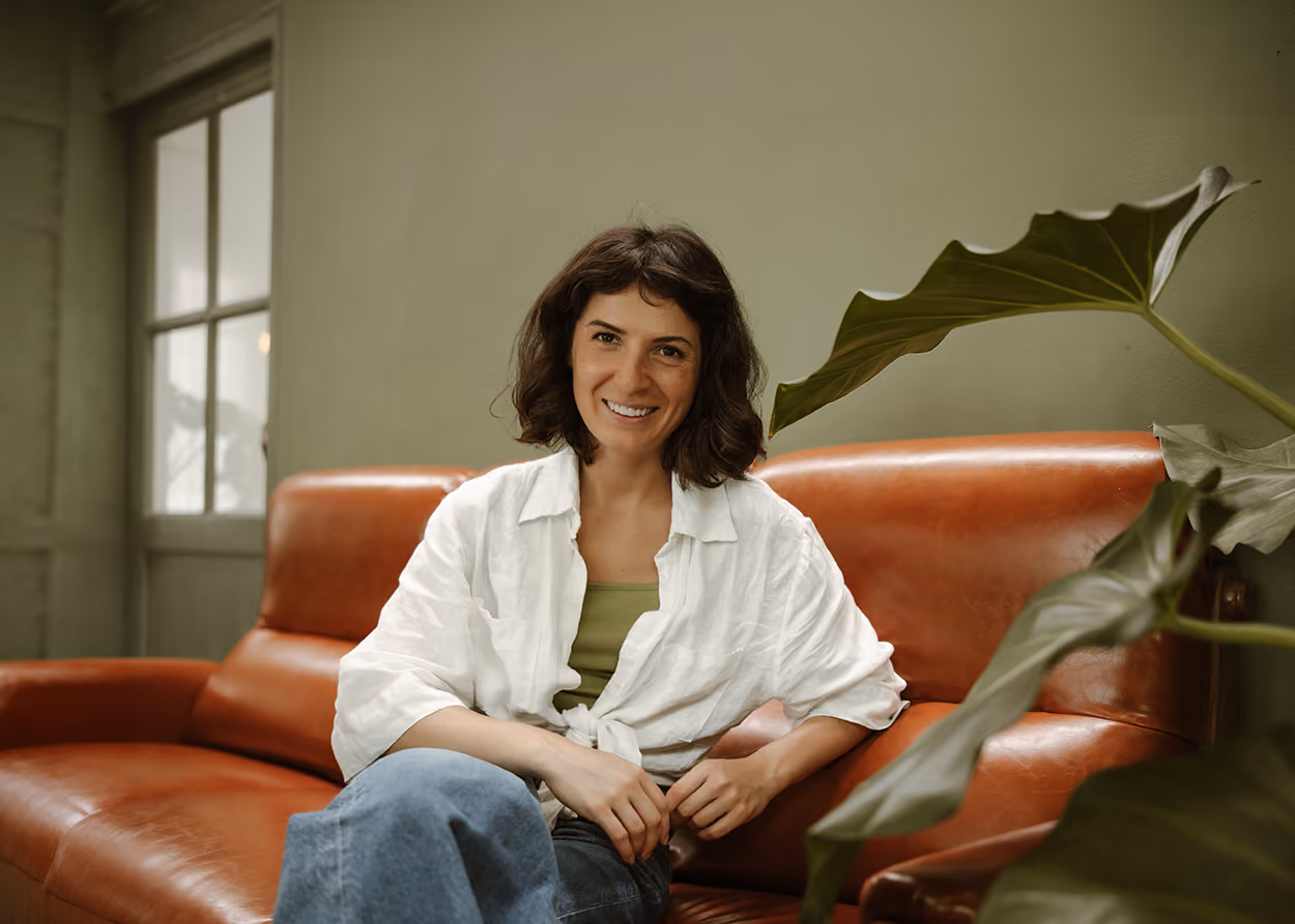 Woman in an open, comfortable conversation with her therapist in a warm office