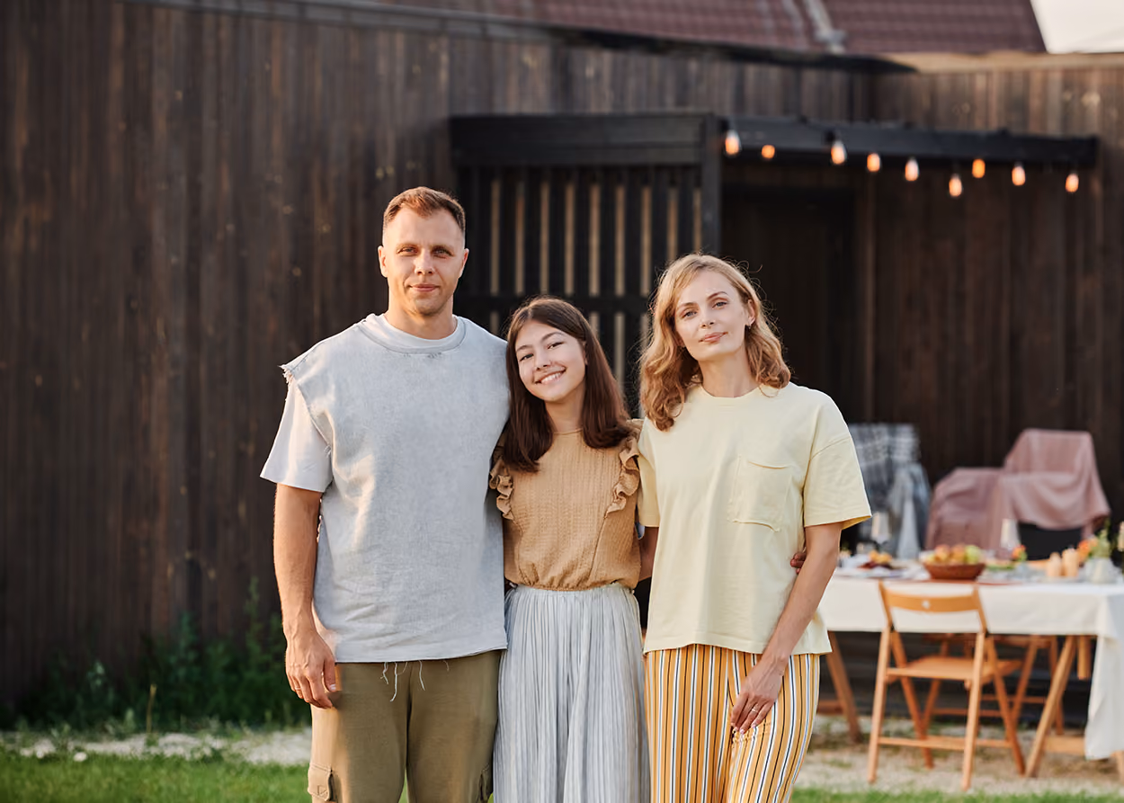 Family sitting together during a family therapy session in a warm, welcoming office