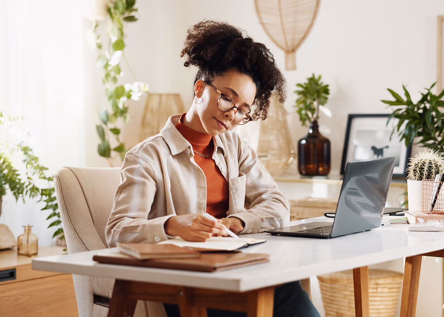 Young professional woman working at office desk.