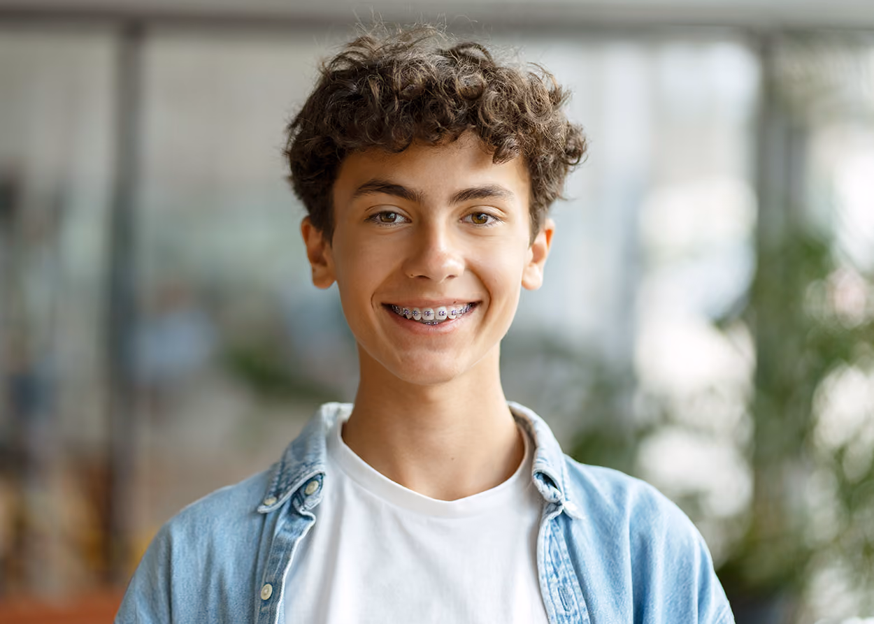 Middle eastern male teenager smiling at camera. Teen therapy in Plano, TX