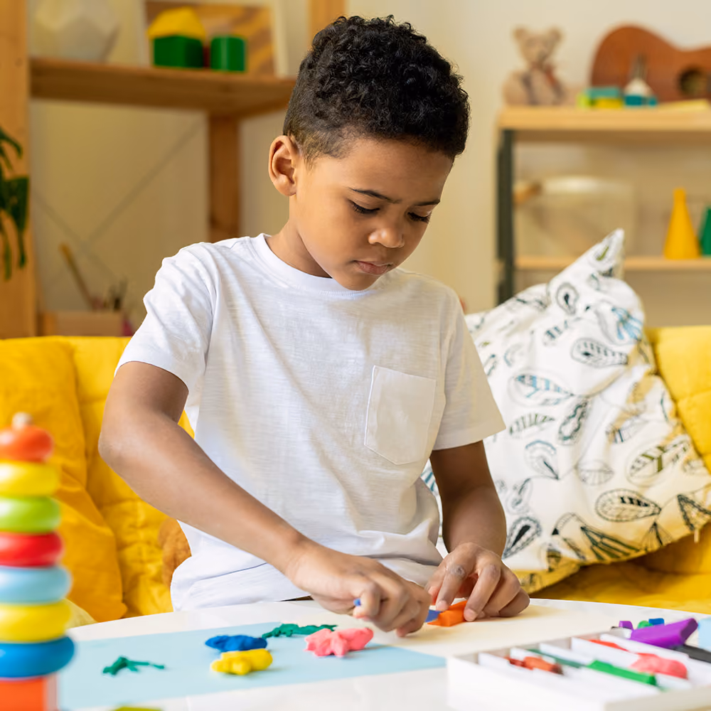 Child engaged in child-centered play therapy with toys in a warm therapy room
