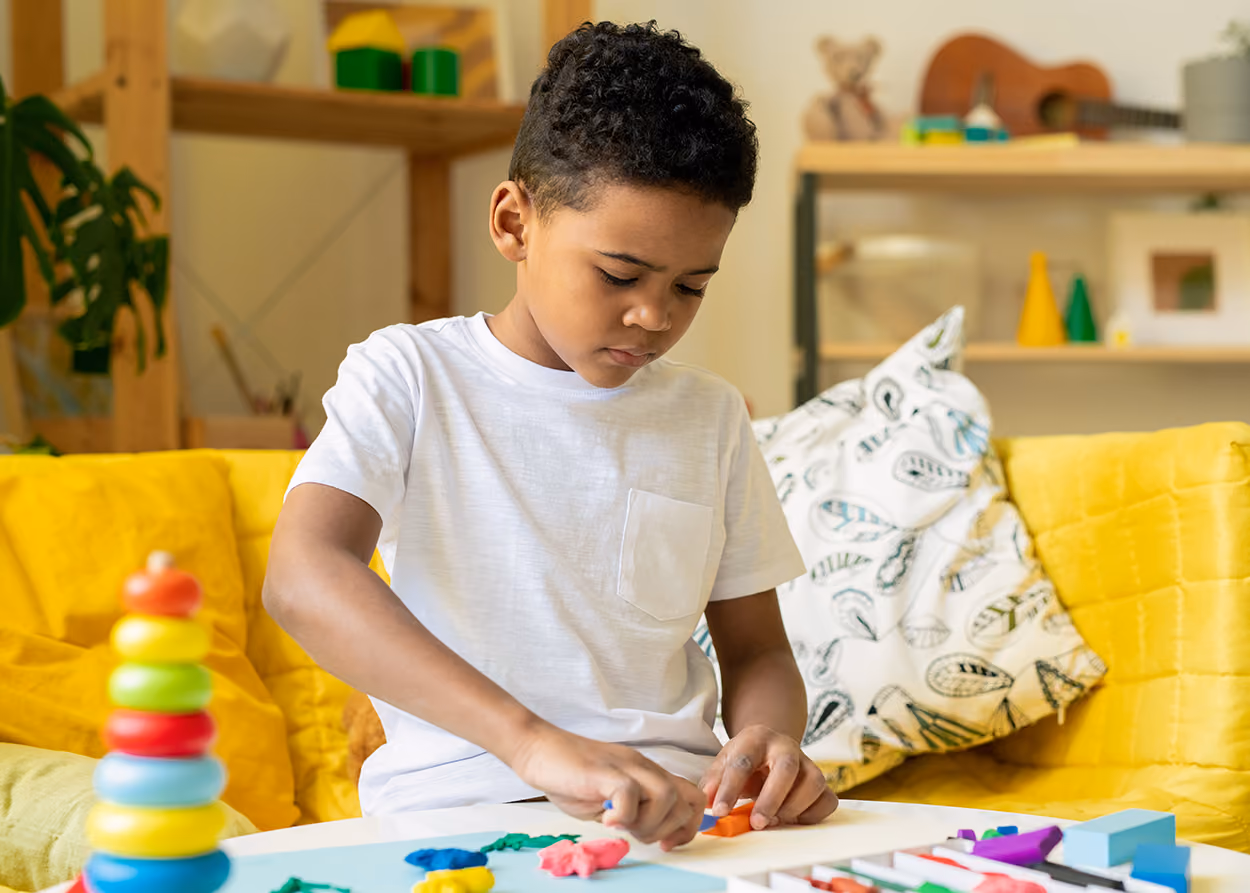 Child engaged in child-centered play therapy with toys in a warm therapy room