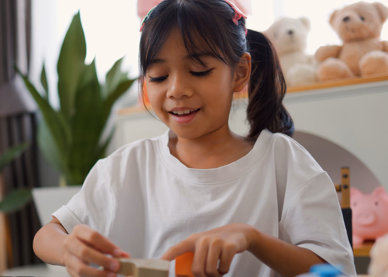 Child engaged in focused play during an ADHD play therapy session in Plano, TX