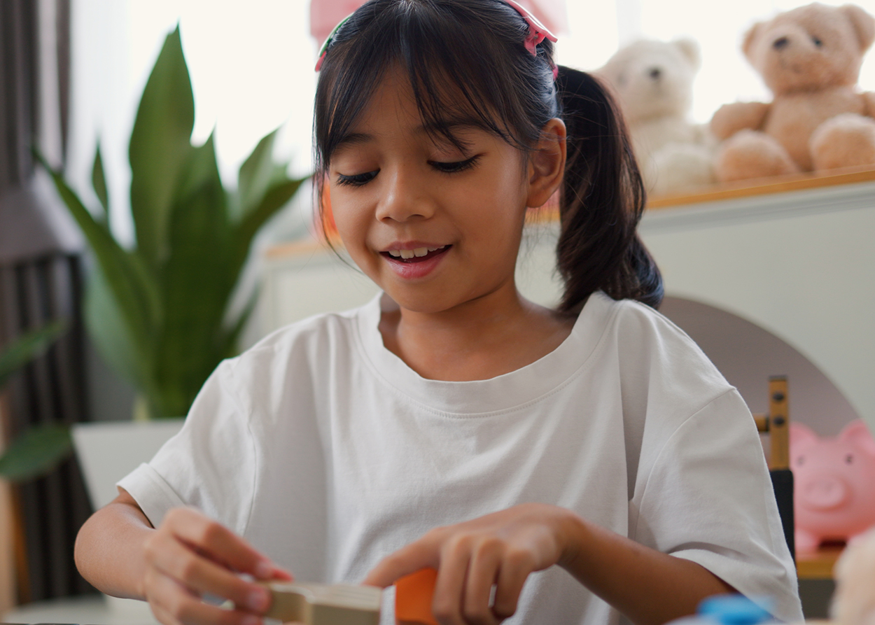 Child engaged in focused play during an ADHD play therapy session in Plano, TX