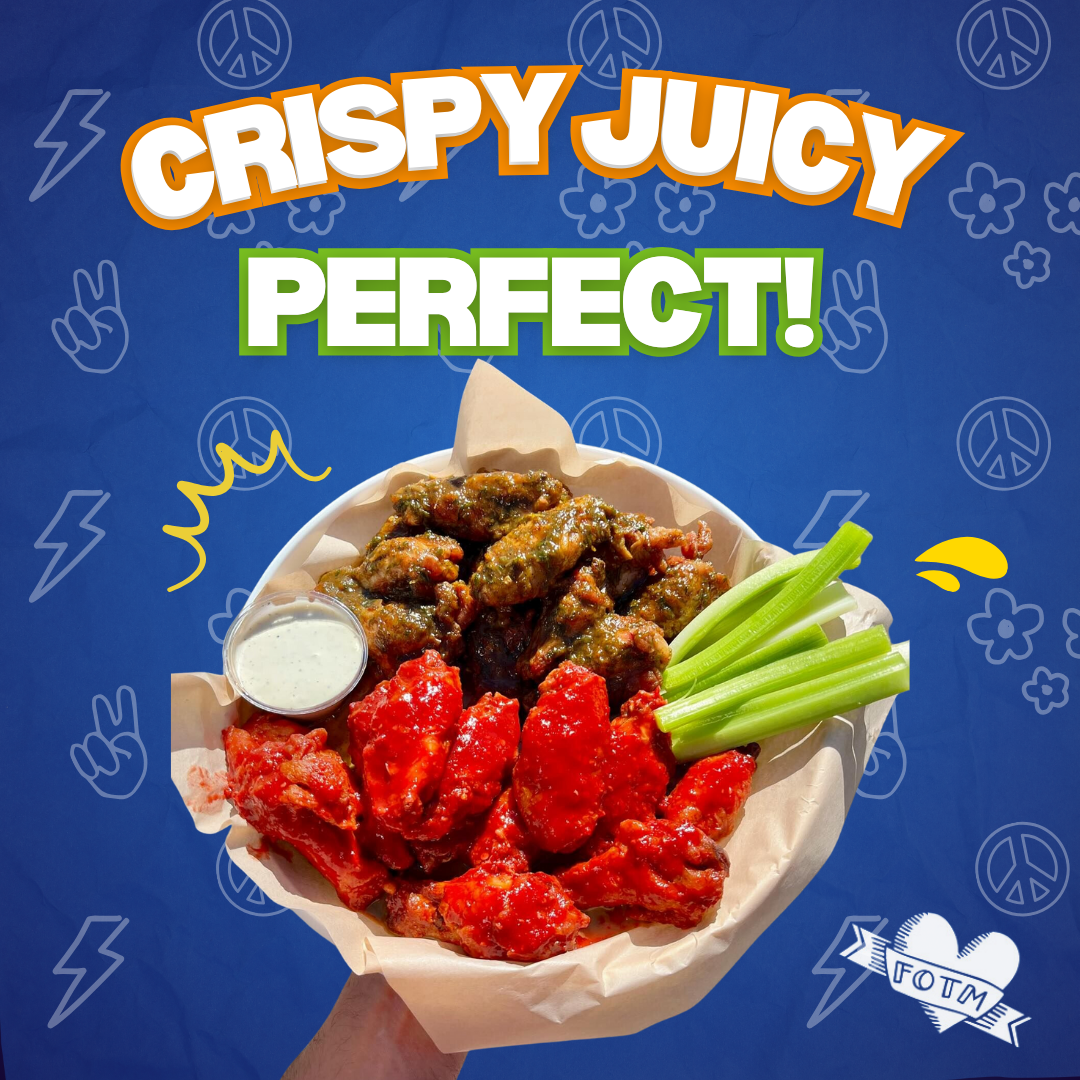 Hand holding a bowl of crispy buffalo wings with celery sticks and ranch dipping sauce.