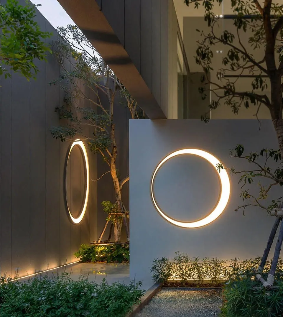 Outdoor ring lighting on a garden wall at dusk