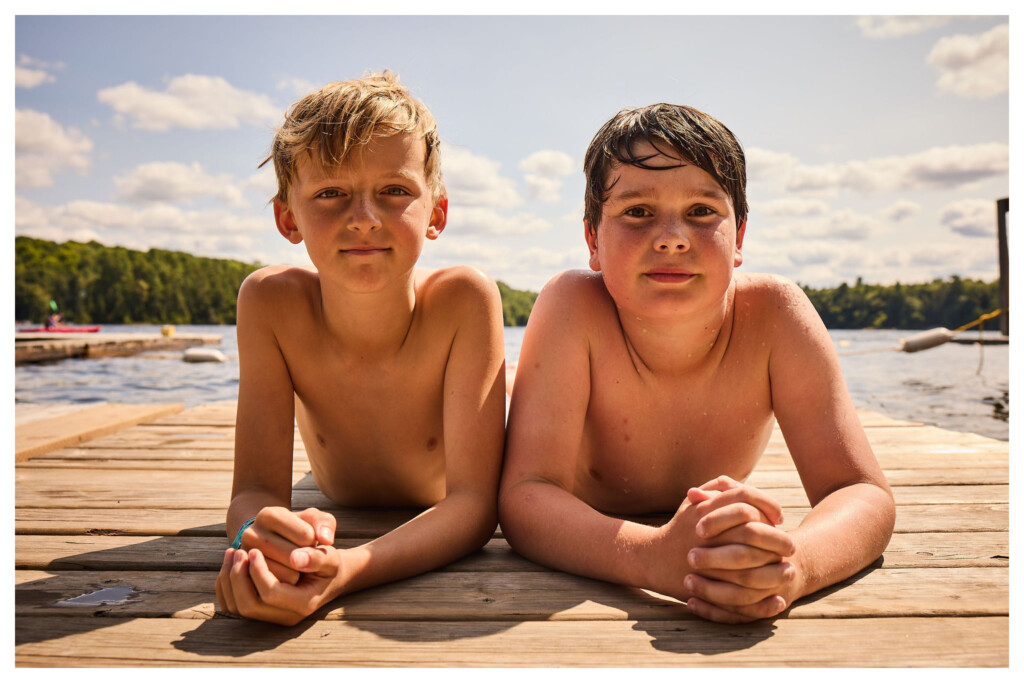 Two boys smiling on the dock at Kilcoo Camp