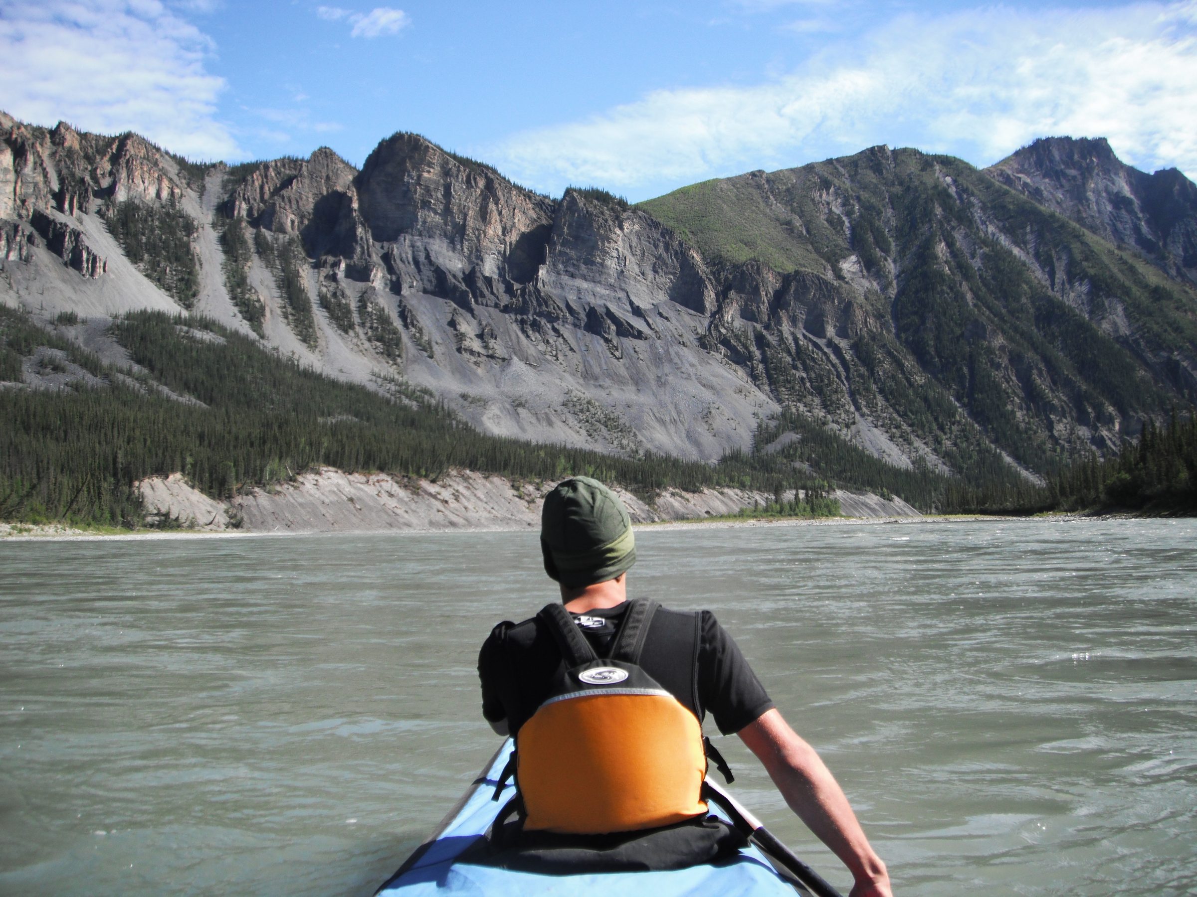 A kayaker paddling on the Nahanni River