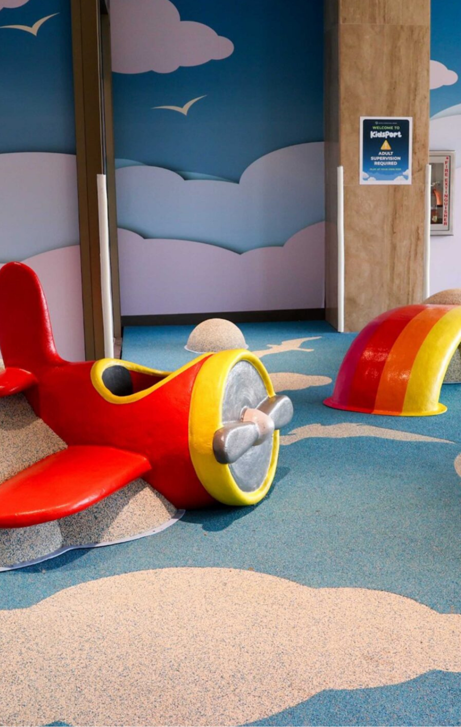 Designer drawing a bus-shaped play structure on a tablet
