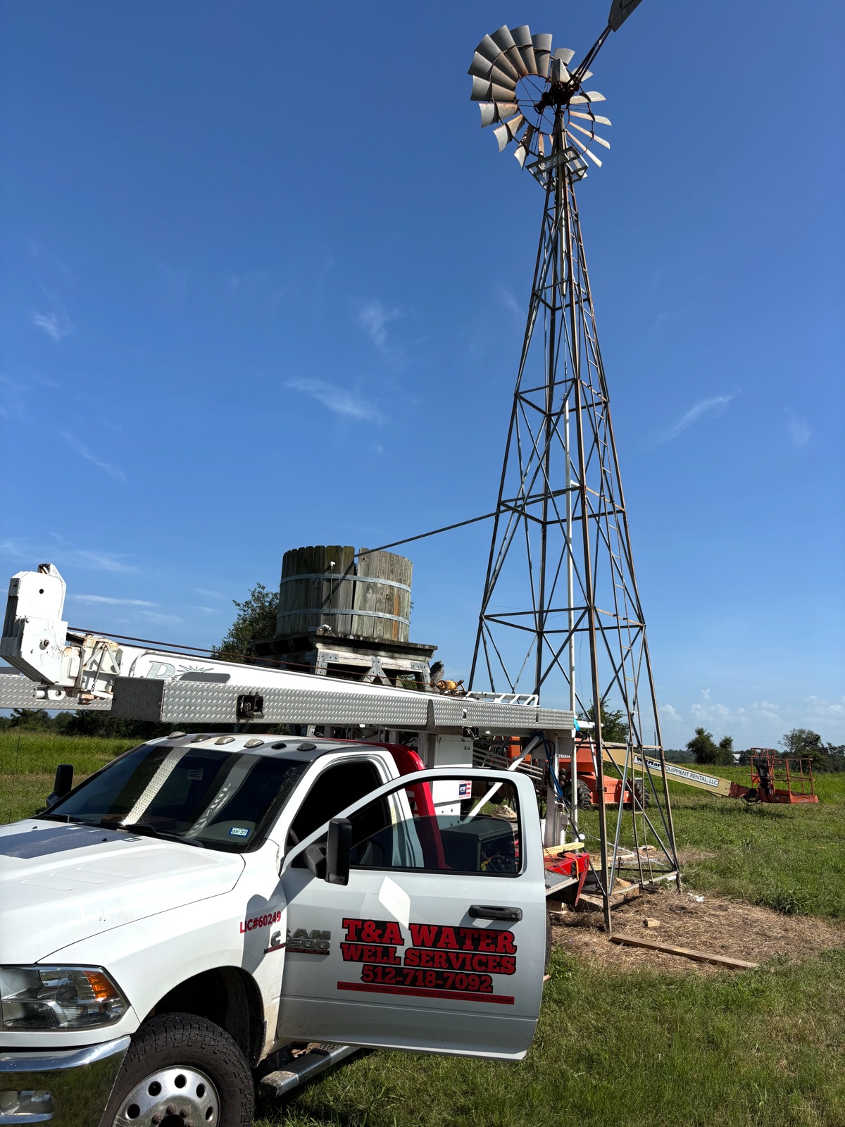 T&A truck beside a windmill and water storage tank on a Central Texas ranch